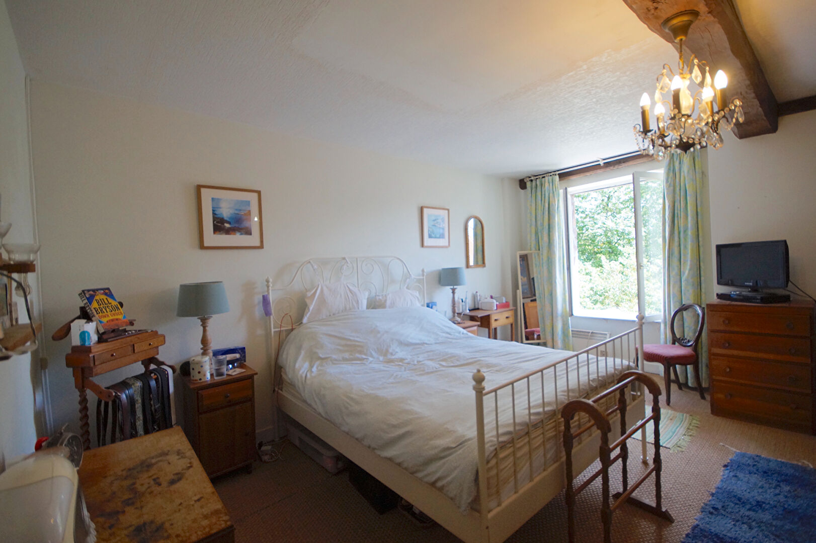 Spacious bedroom featuring a double bed, natural light, and views in Manche, Normandy, France.