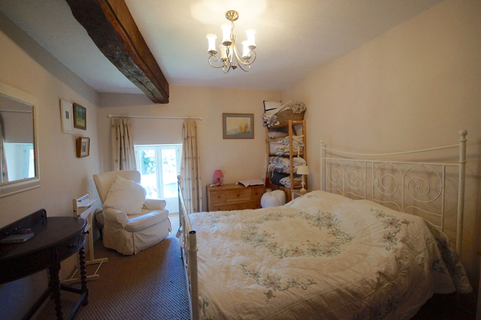 Four-bedroom property in Manche, Normandy, featuring a cosy bedroom with natural light and classic decor.