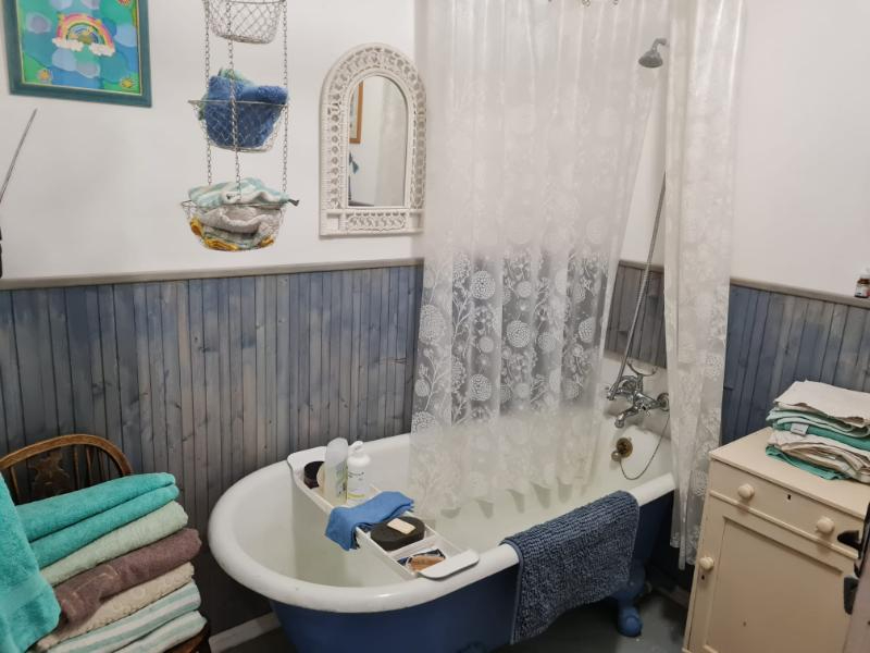 Four-bedroom property in Manche, Normandy, featuring a vintage bathtub and decorative wall elements.