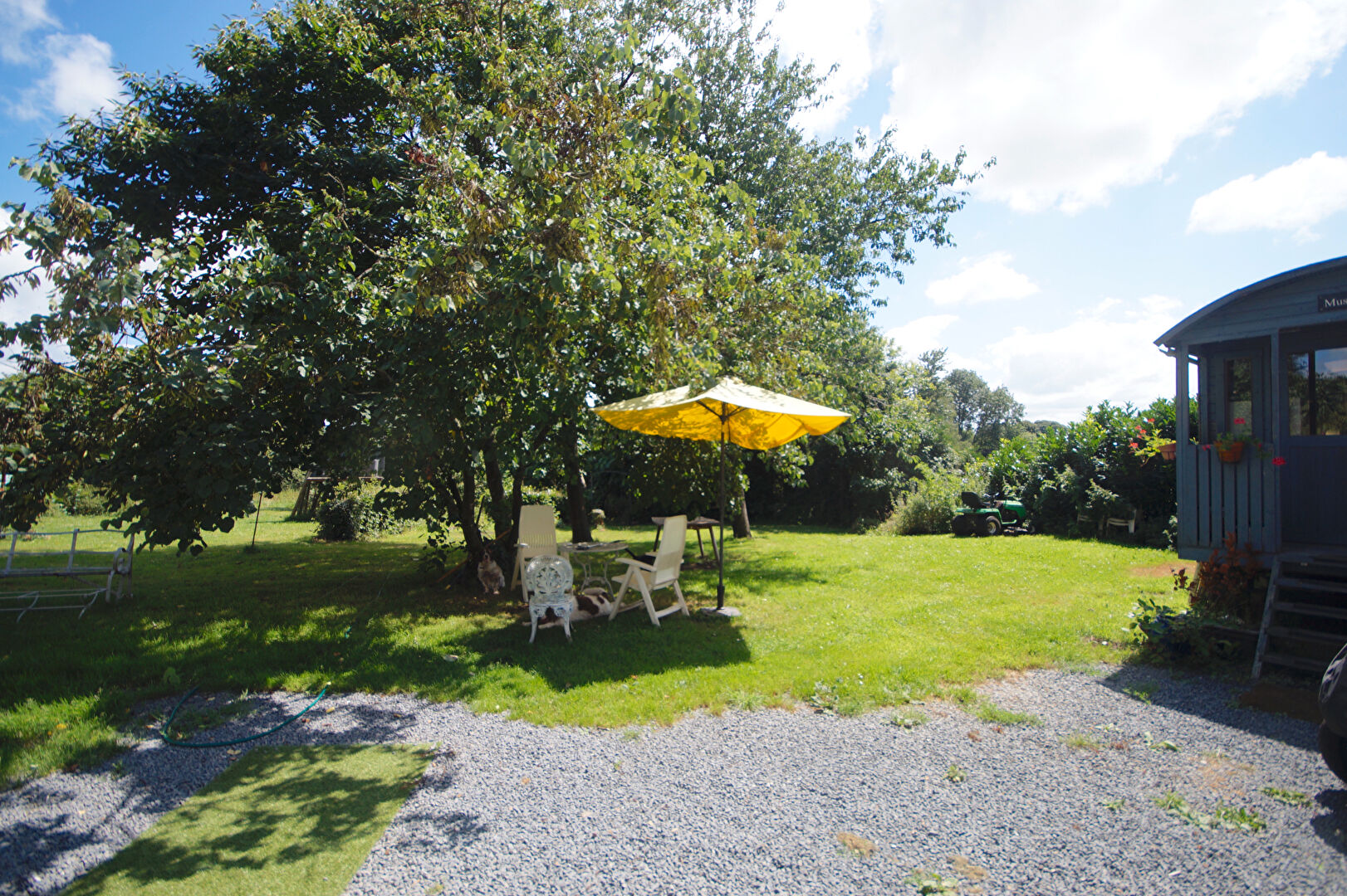 Property with garden space, featuring a parasol and seating area in Manche, Normandy, postcode 50450.