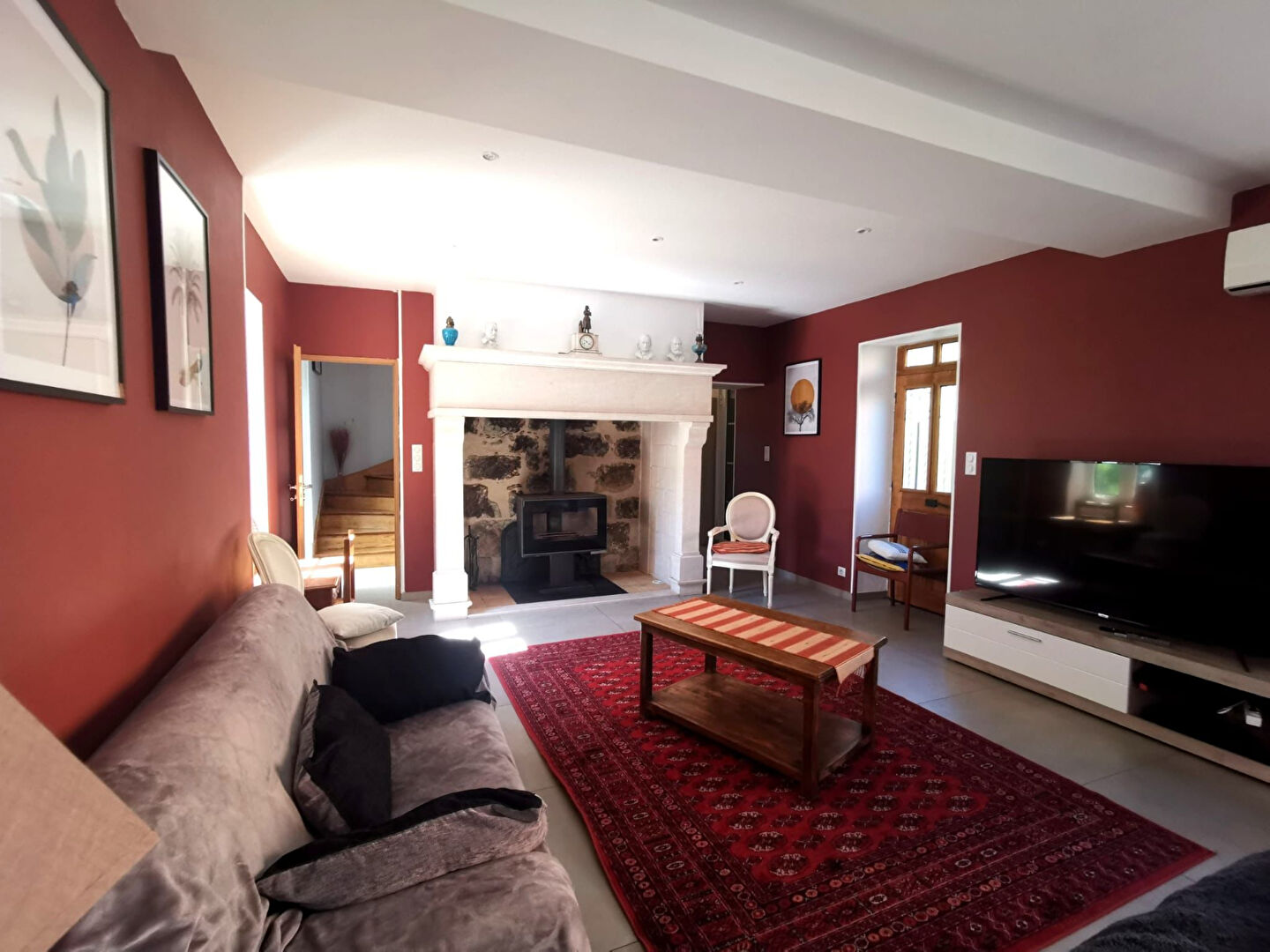 Spacious living room in a property located in Corrèze, Nouvelle-Aquitaine, featuring a fireplace and modern decor.
