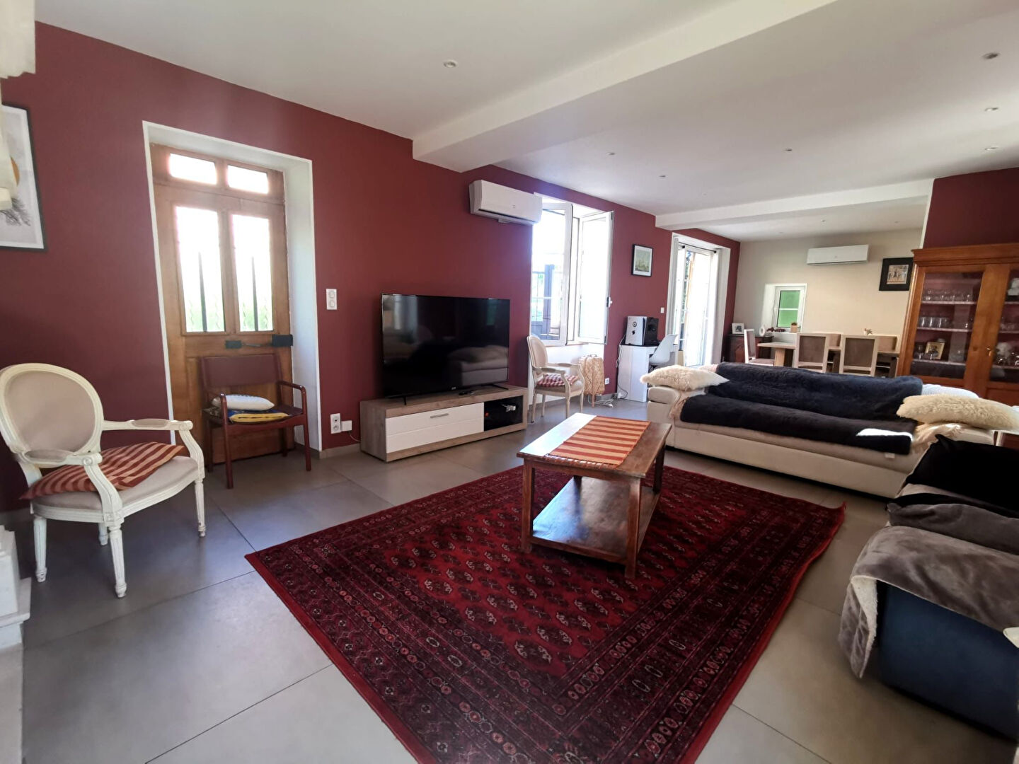 Spacious property in Corrèze, Nouvelle-Aquitaine, featuring a modern living area with large windows and stylish decor.