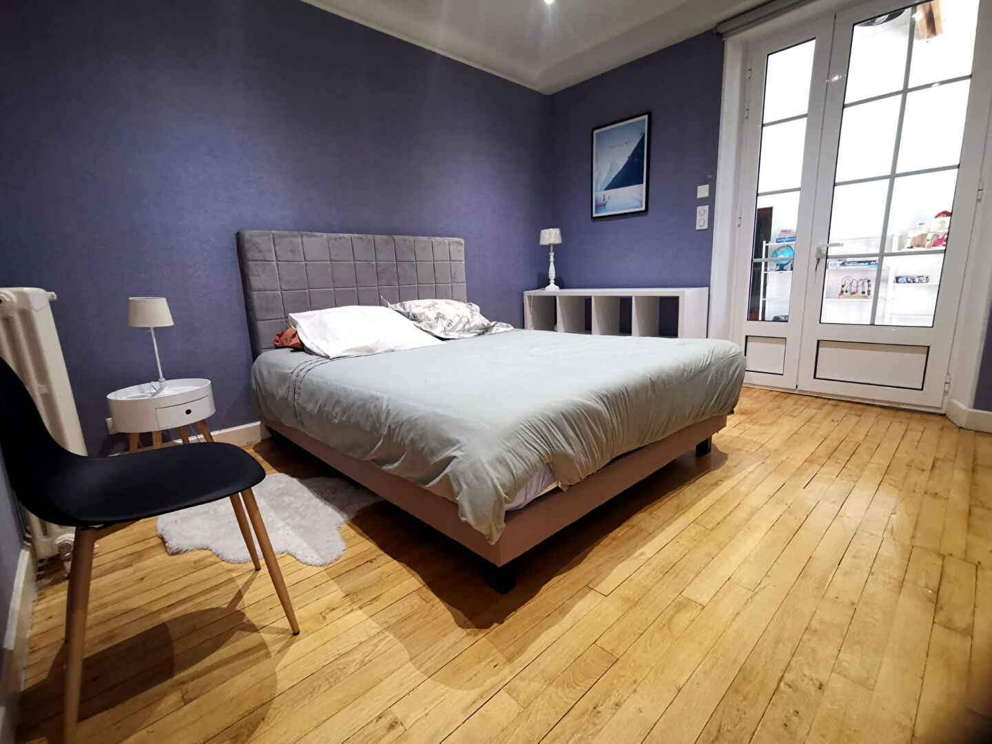 Spacious property in Corrèze, Nouvelle-Aquitaine with wooden flooring and ample natural light in the bedroom.