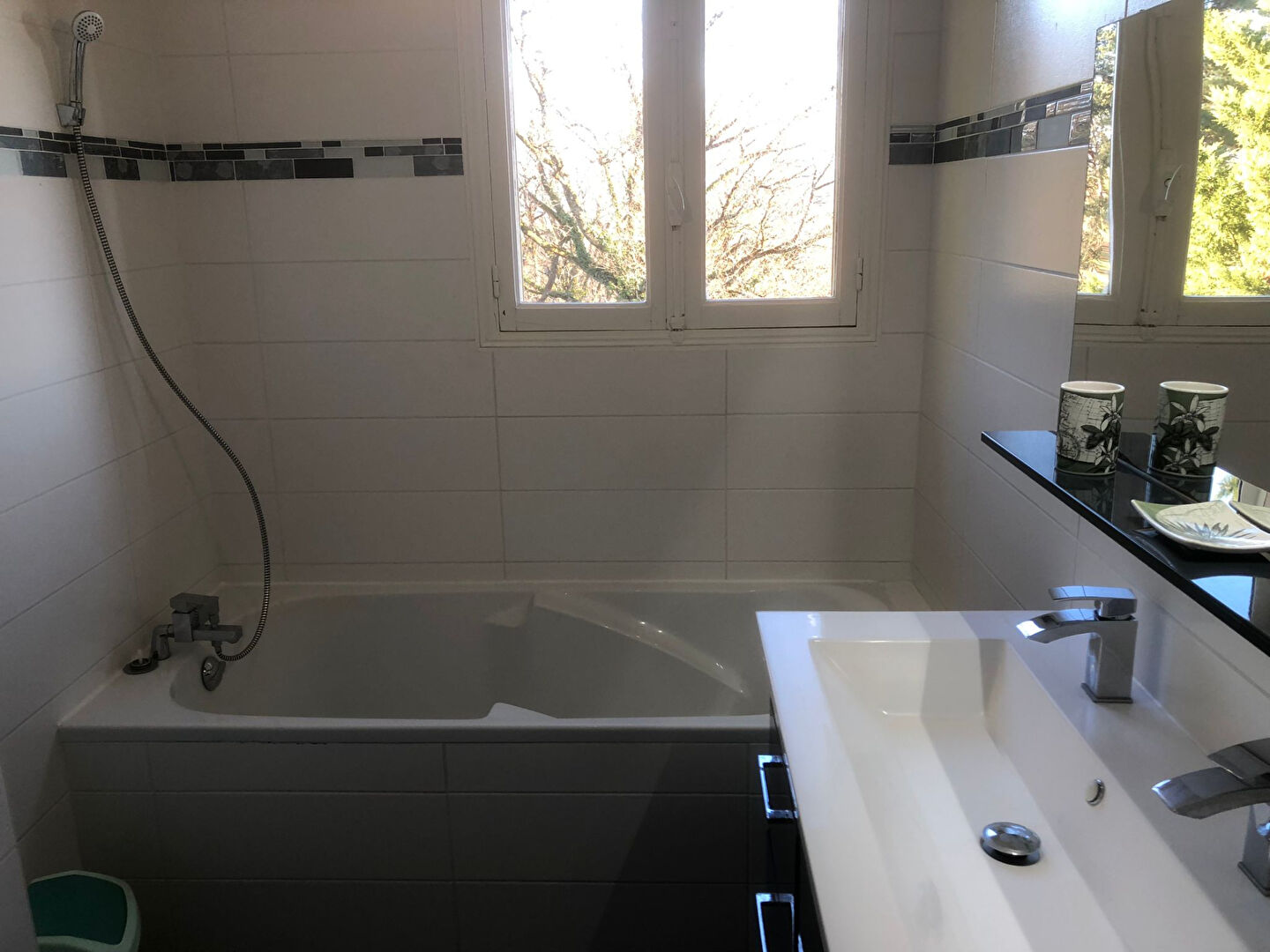Spacious bathroom featuring a bath, modern sink, and large windows in Corrèze, Nouvelle-Aquitaine.