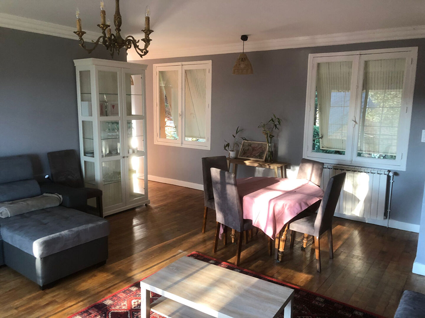 Spacious living area featuring a dining table and comfortable seating in a property located in Corrèze, Nouvelle-Aquitaine.
