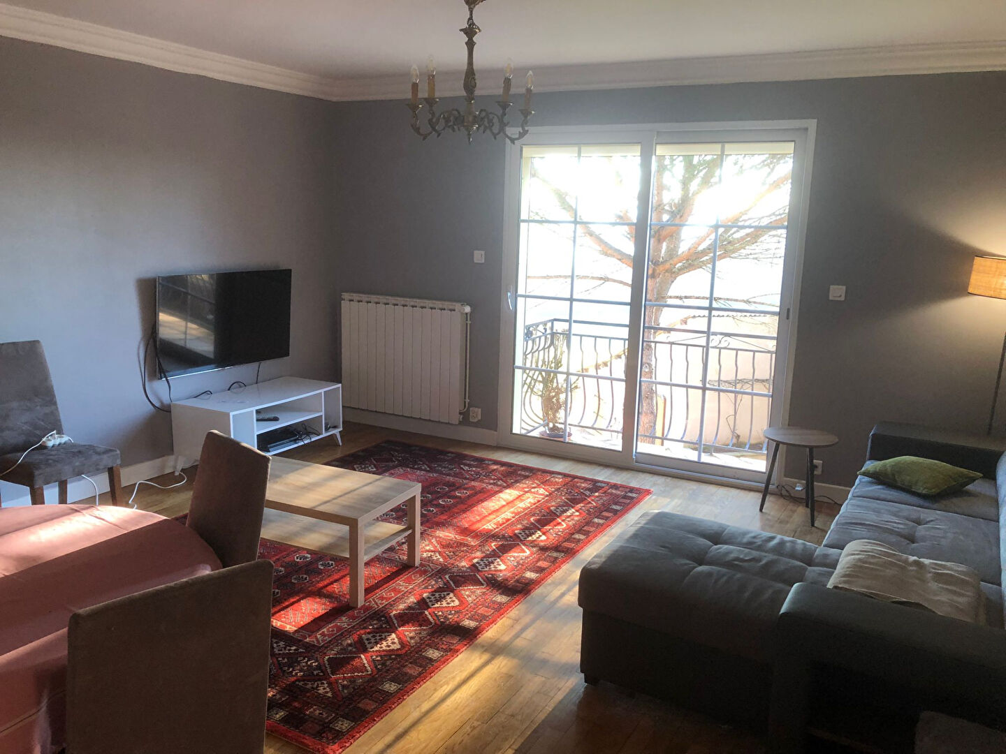 Spacious living area in a property located in Corrèze, Nouvelle-Aquitaine, featuring large windows and modern furnishings.