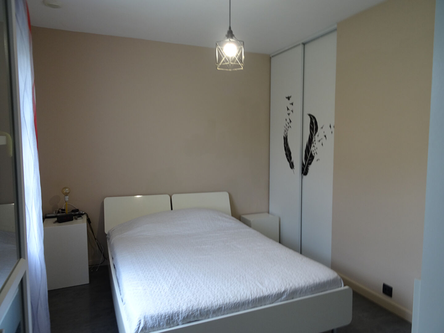 Modern property in Vendée featuring a spacious bedroom with minimalist design and built-in wardrobe.