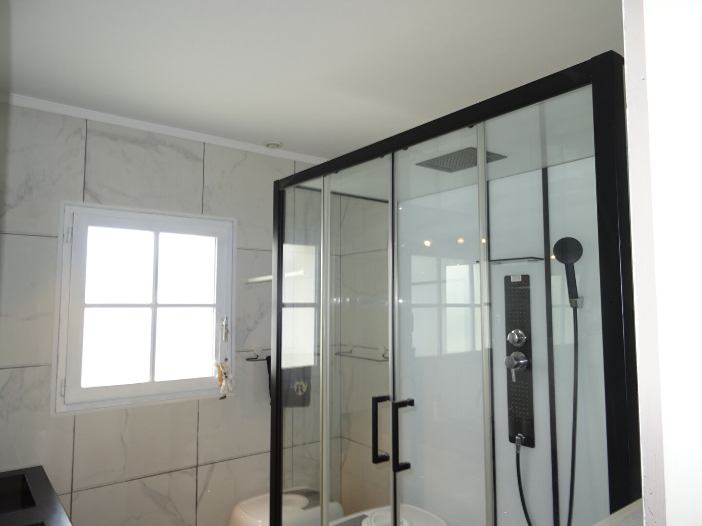 Modern bathroom featuring a glass shower enclosure in a property located in Vendée, Pays-de-la-Loire, postcode 85150.