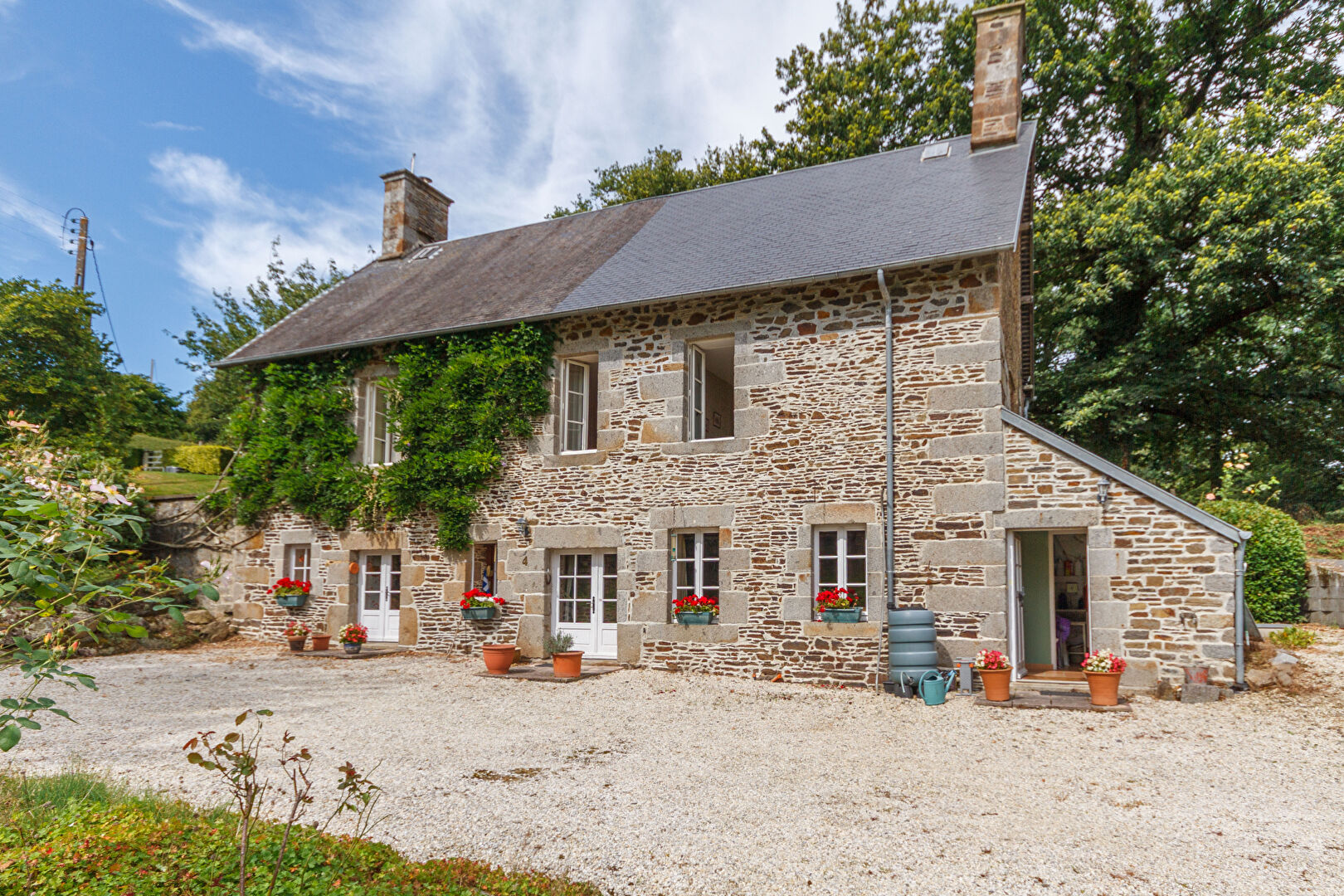 Charming property in Manche, Normandy, featuring stone architecture, garden space, and four bedrooms.