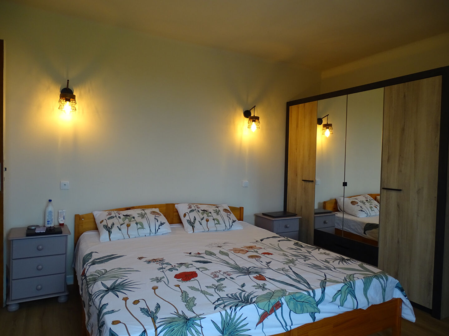 Bright bedroom featuring a double bed, wardrobe, and bedside tables in Finistère, Brittany, 29270.