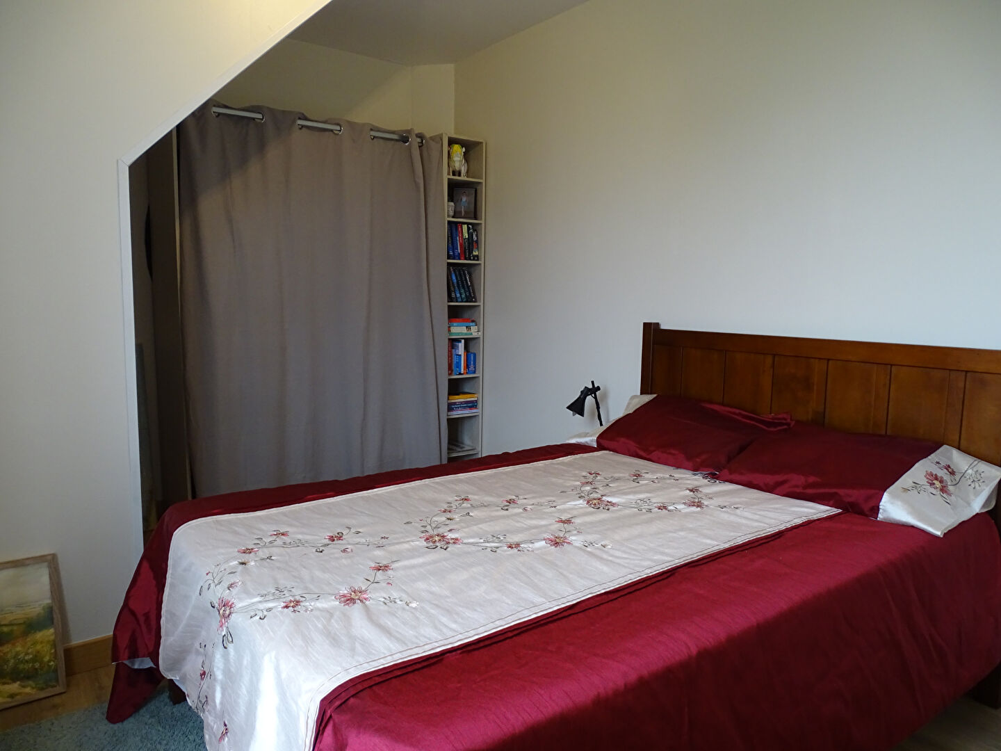 Three-bedroom property in Finistère, Brittany, featuring a cosy bedroom with wooden furnishings and soft textiles.