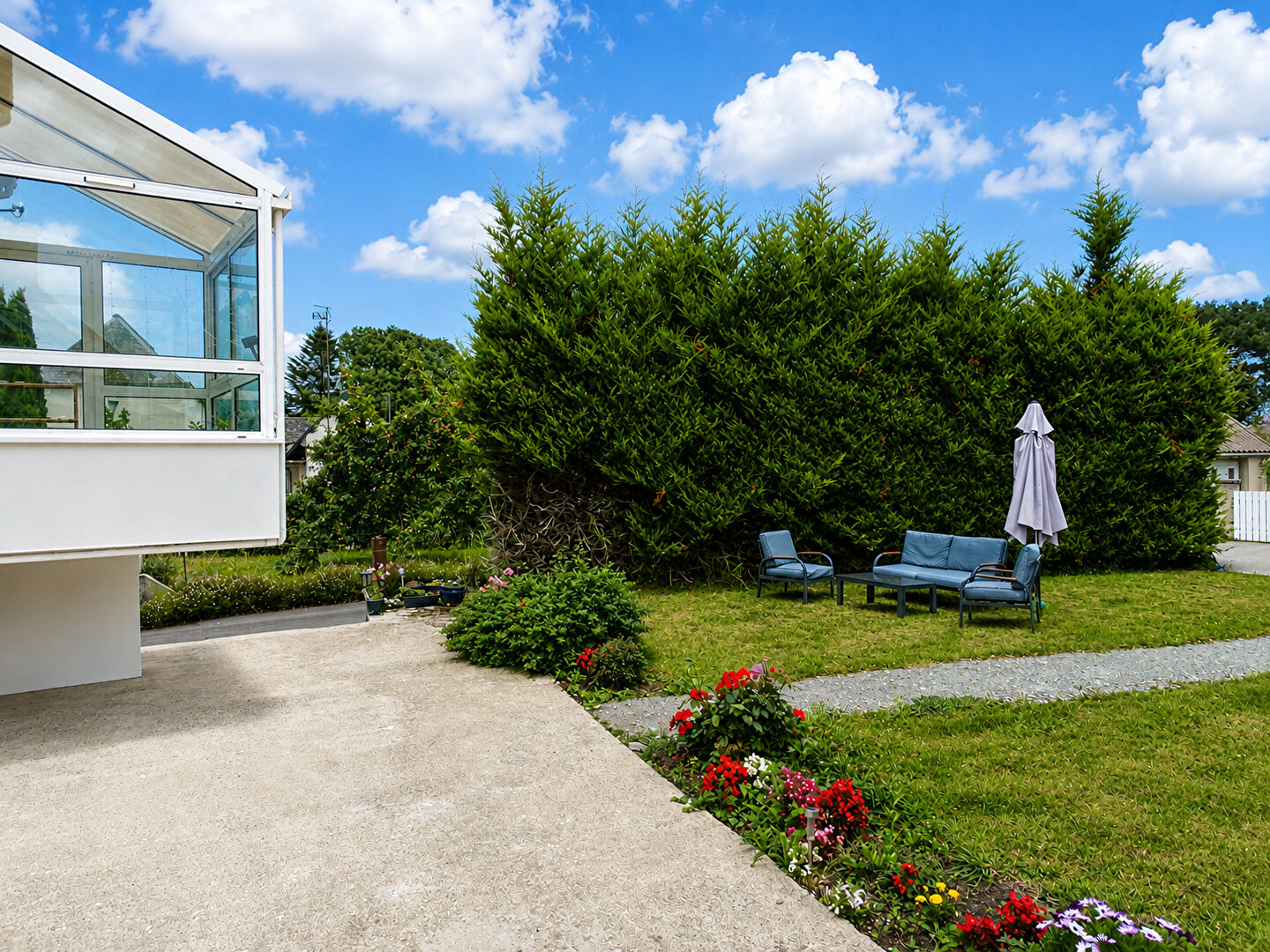 Spacious garden with seating area and a view of the property in Finistère, Brittany, featuring ample outdoor space.
