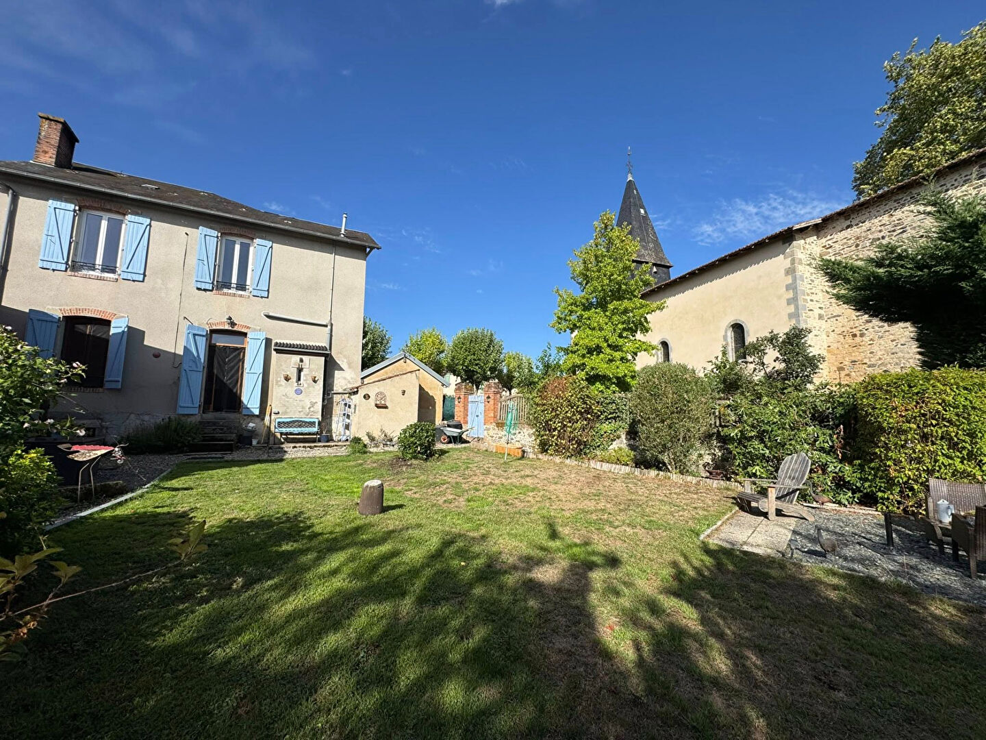 Three-bedroom property in Haute-Vienne featuring a garden and charming architecture against a clear blue sky.
