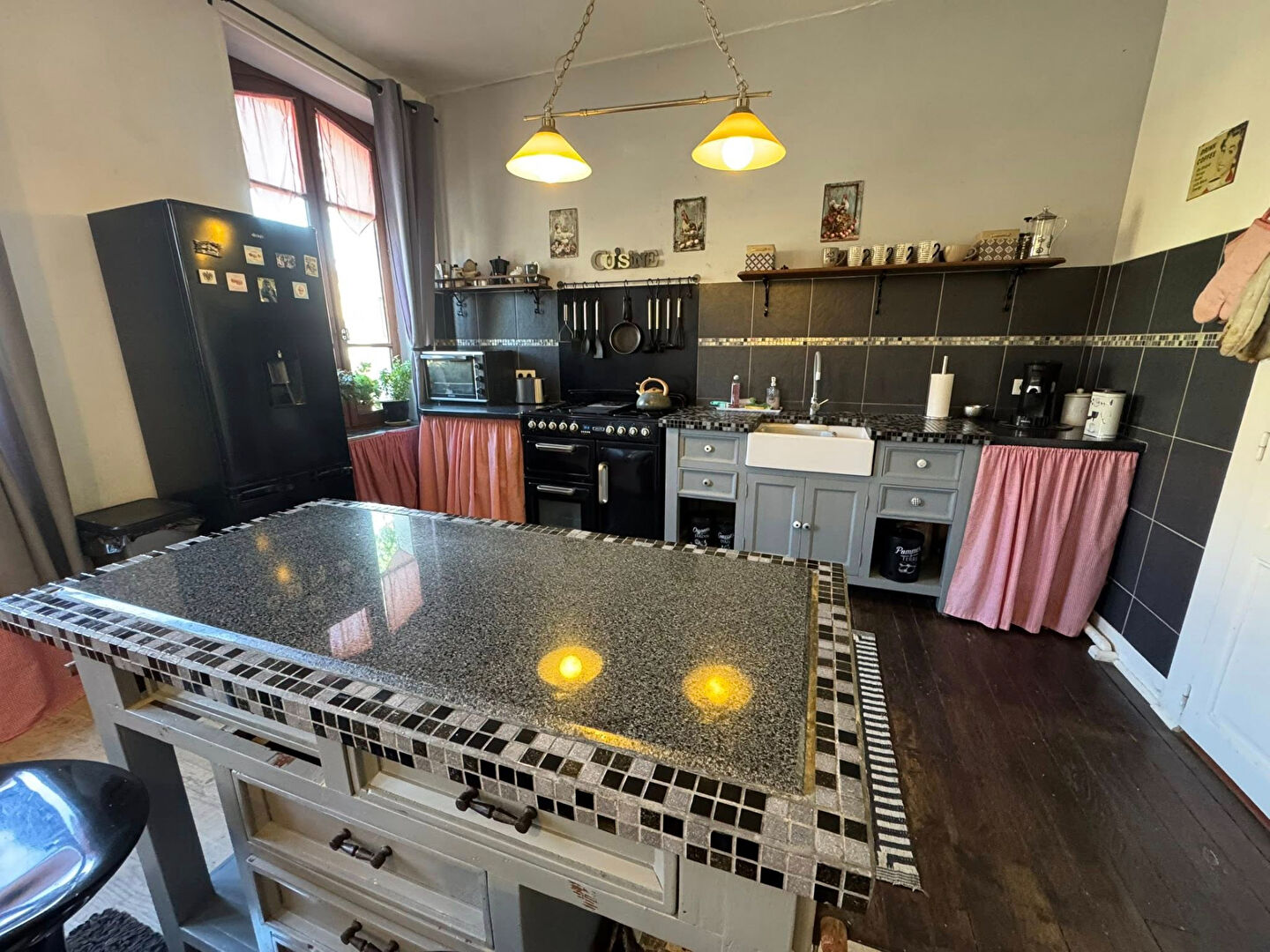 Stylish property in Haute-Vienne featuring a modern kitchen with a mosaic island and elegant furnishings.