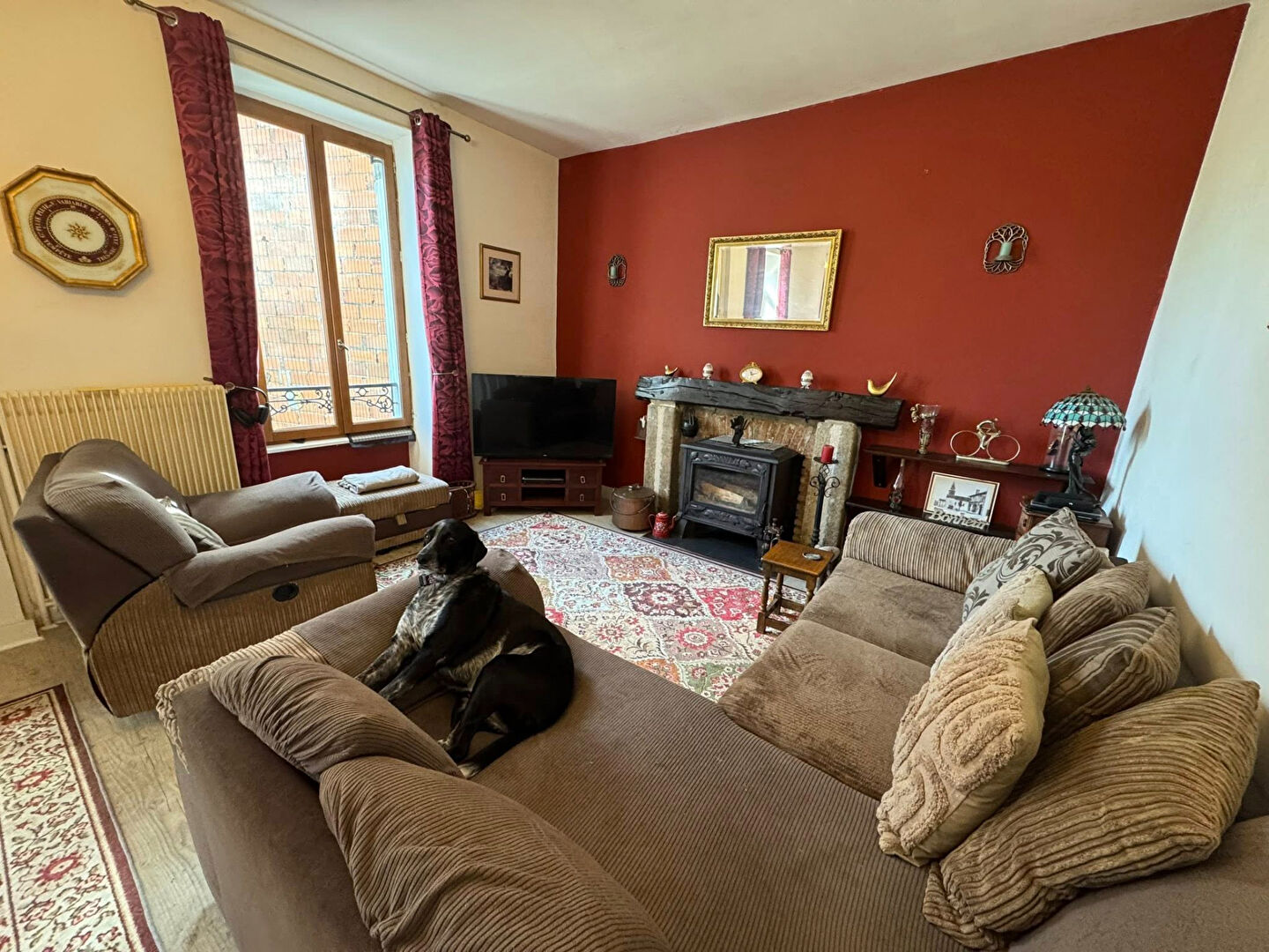 Cosy living room with three bedrooms in Haute-Vienne, Nouvelle-Aquitaine, featuring a fireplace and comfortable seating.