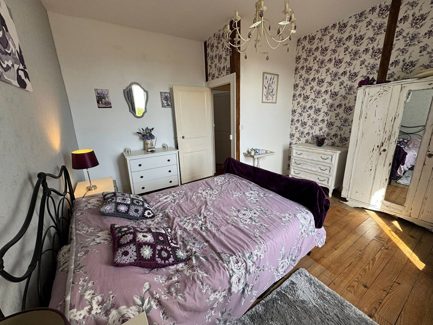 Spacious property in Haute-Vienne with a floral-themed bedroom, wooden flooring, and ample natural light.