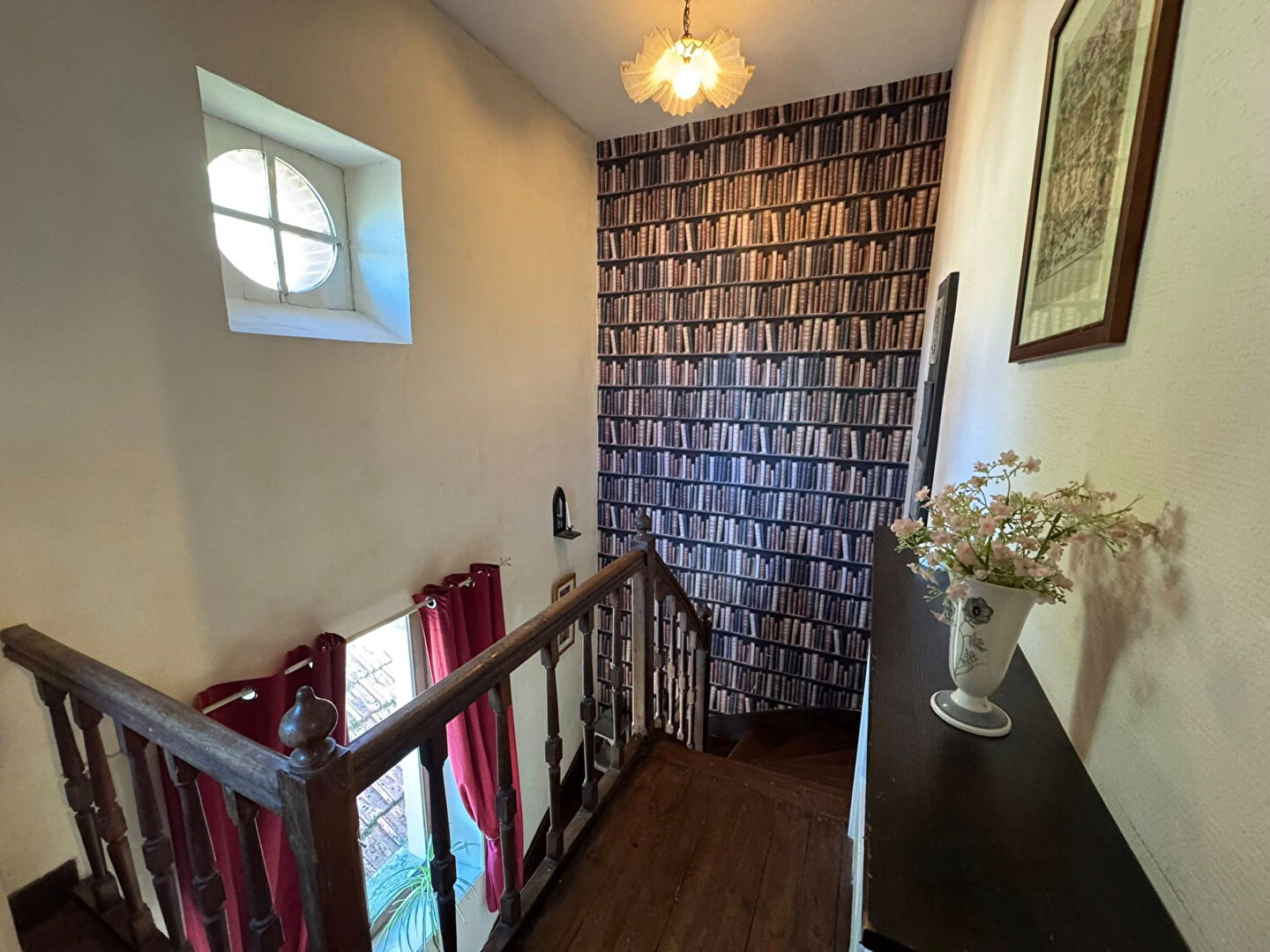 Staircase in a property located in Haute-Vienne, Nouvelle-Aquitaine, featuring decorative wallpaper and natural light.
