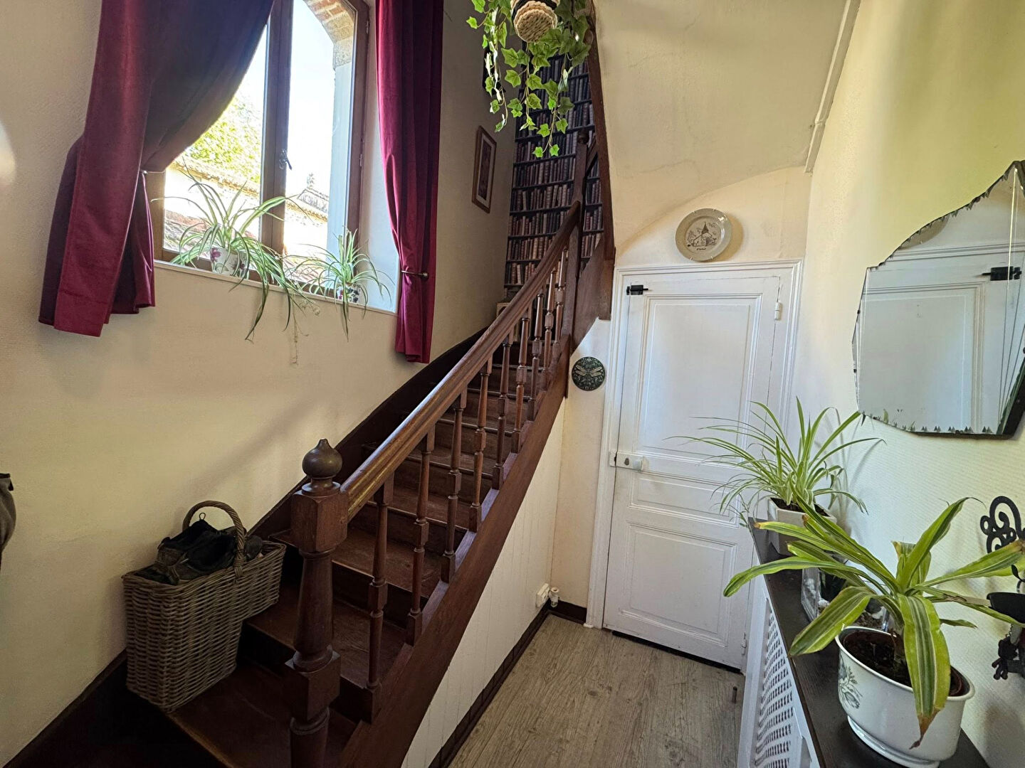 Bright hallway with wooden staircase and plants, located in Haute-Vienne, Nouvelle-Aquitaine, featuring a property type.