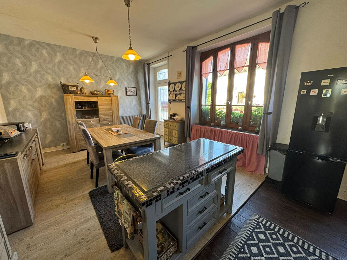 Spacious property in Haute-Vienne, Nouvelle-Aquitaine, featuring a modern kitchen, dining area, and large windows.