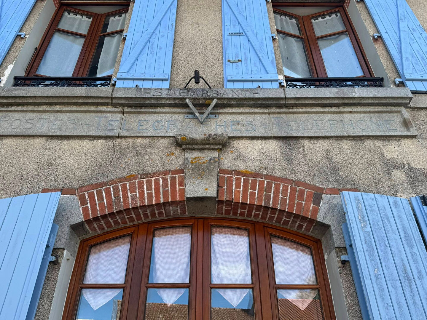 Property in Haute-Vienne, Nouvelle-Aquitaine, featuring blue shutters and historic architecture.