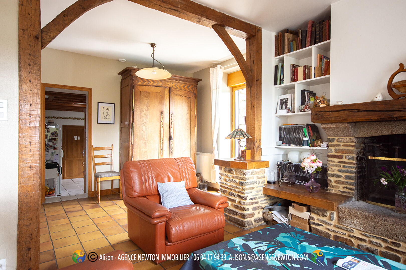 Four-bedroom property in Manche, Normandy, featuring a comfortable living area and a rustic fireplace.