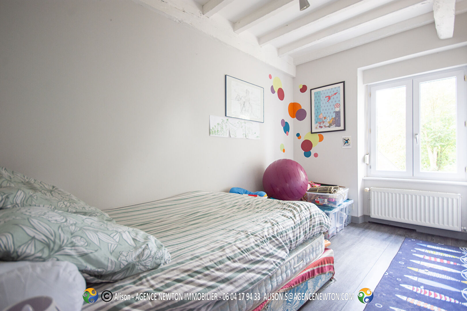 Four-bedroom property in Manche, Normandy, featuring a bright room with natural light and colourful wall decor.