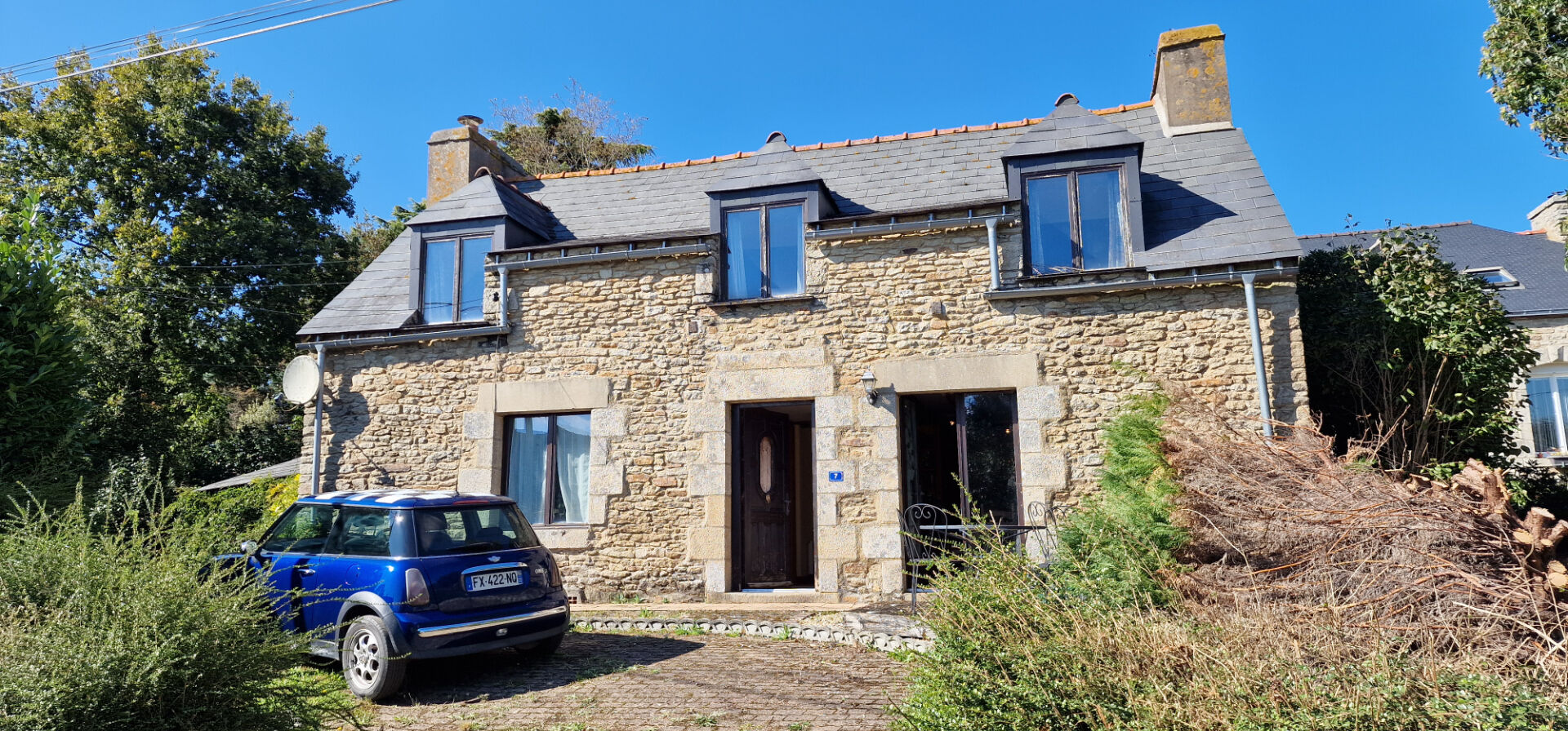 Charming property in Morbihan, Brittany, featuring stone exterior, three bedrooms, and a landscaped garden.