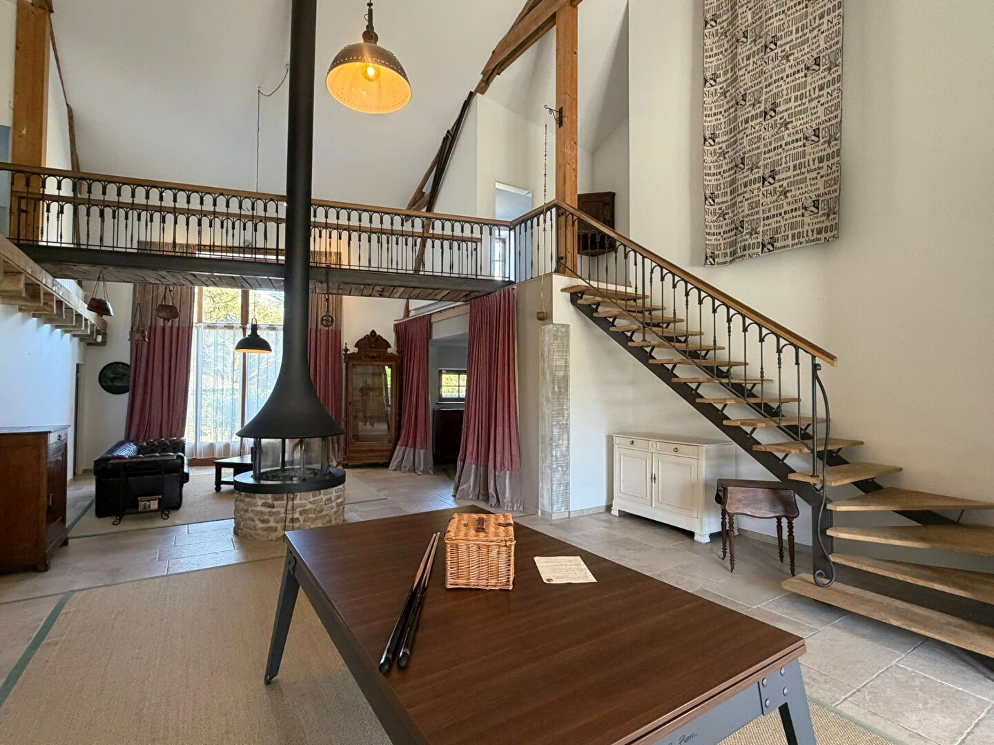 Spacious property in Haute-Vienne with a modern staircase, fireplace, and large windows for natural light.