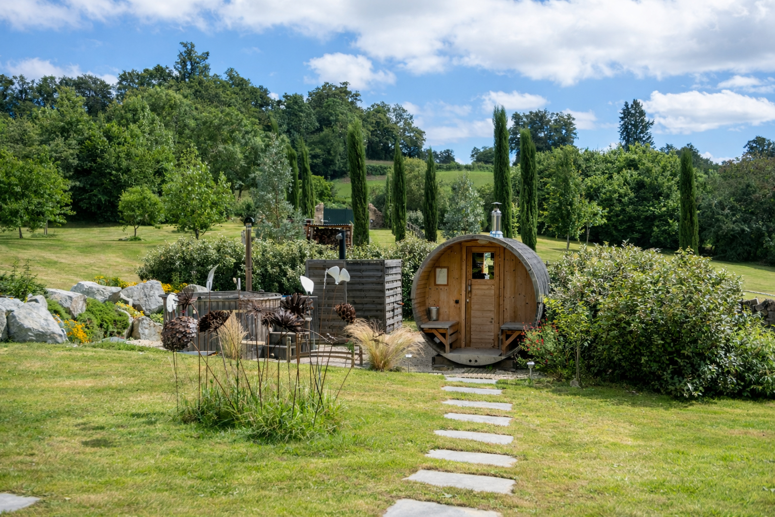 Property in Haute-Vienne, Nouvelle-Aquitaine, featuring a garden with a unique wooden structure and landscaped areas.