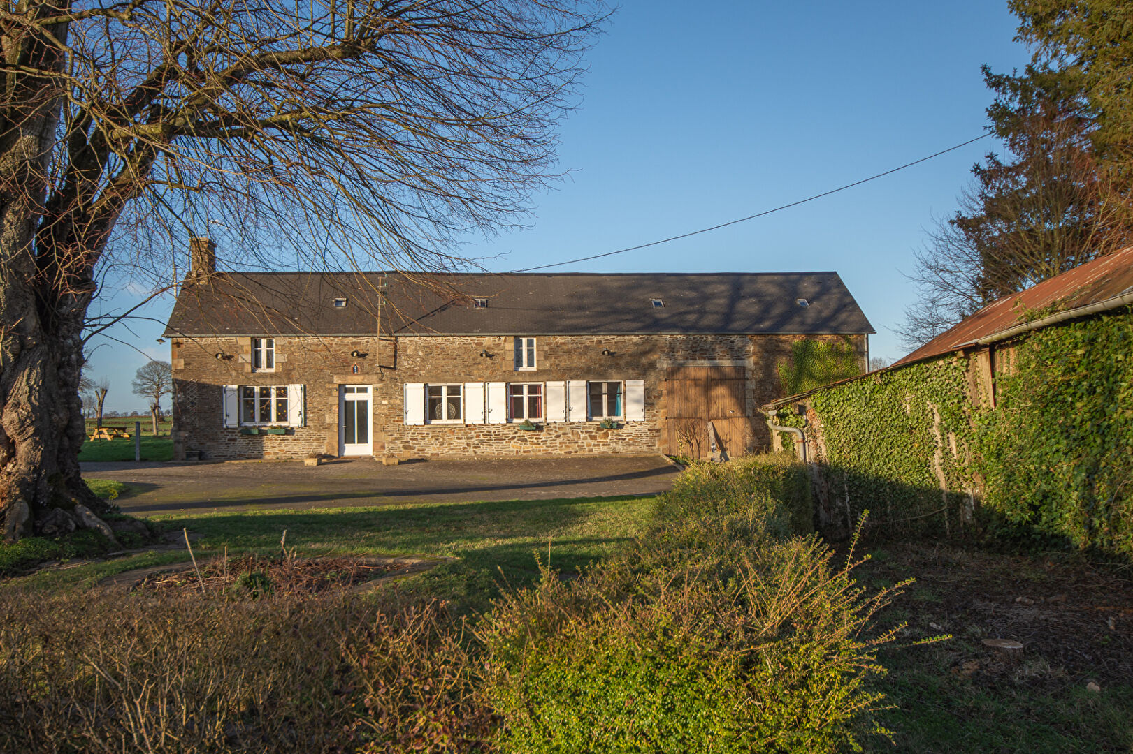 Traditional property in Ille-et-Vilaine, Brittany, featuring stone walls and a spacious garden area.