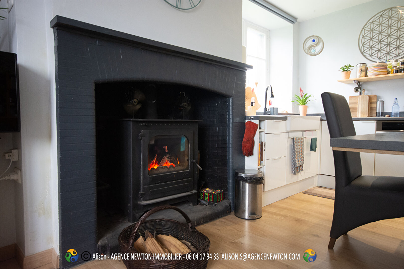 Cozy interior of a property in Ille-et-Vilaine, featuring a fireplace, modern kitchen, and inviting atmosphere.