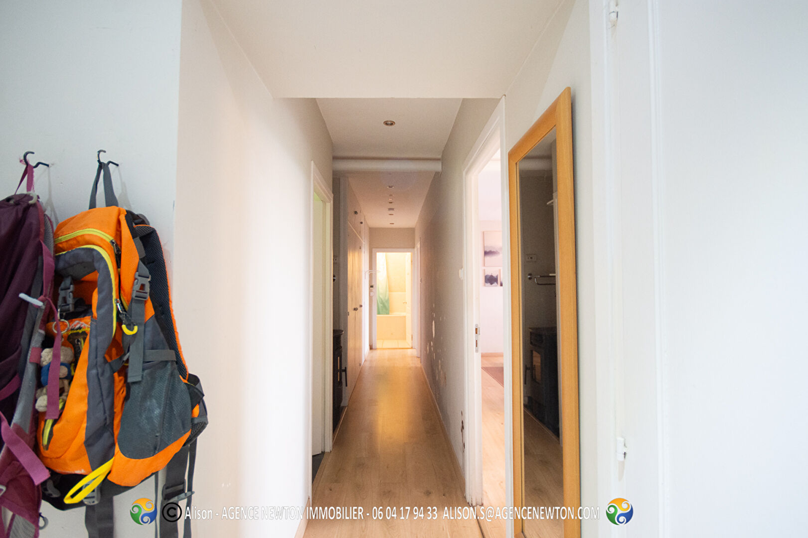 Bright corridor leading to a two-bedroom property in Ille-et-Vilaine, Brittany, featuring modern finishes and natural light.