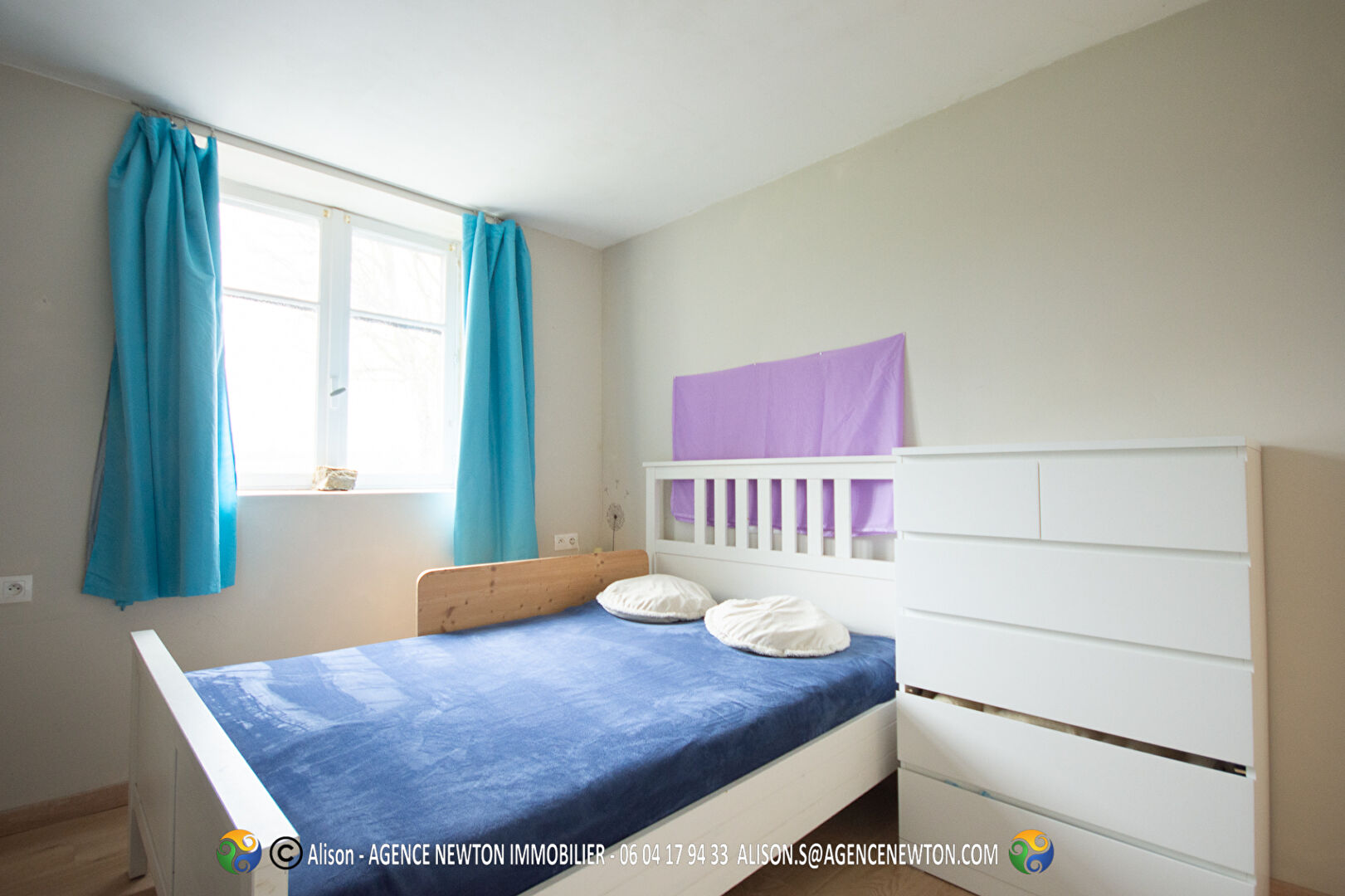 Bright bedroom featuring a double bed and white furniture in Ille-et-Vilaine, Brittany, with natural light and simple decor.