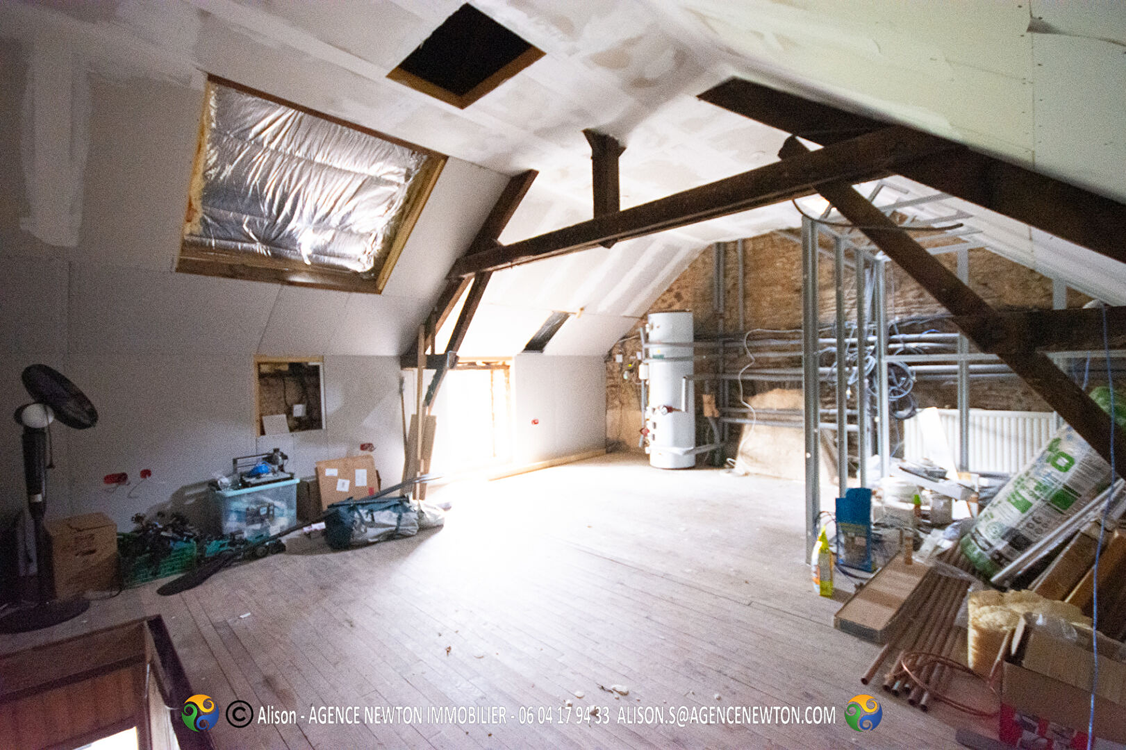 Spacious property in Ille-et-Vilaine featuring exposed beams, large windows, and renovation potential.