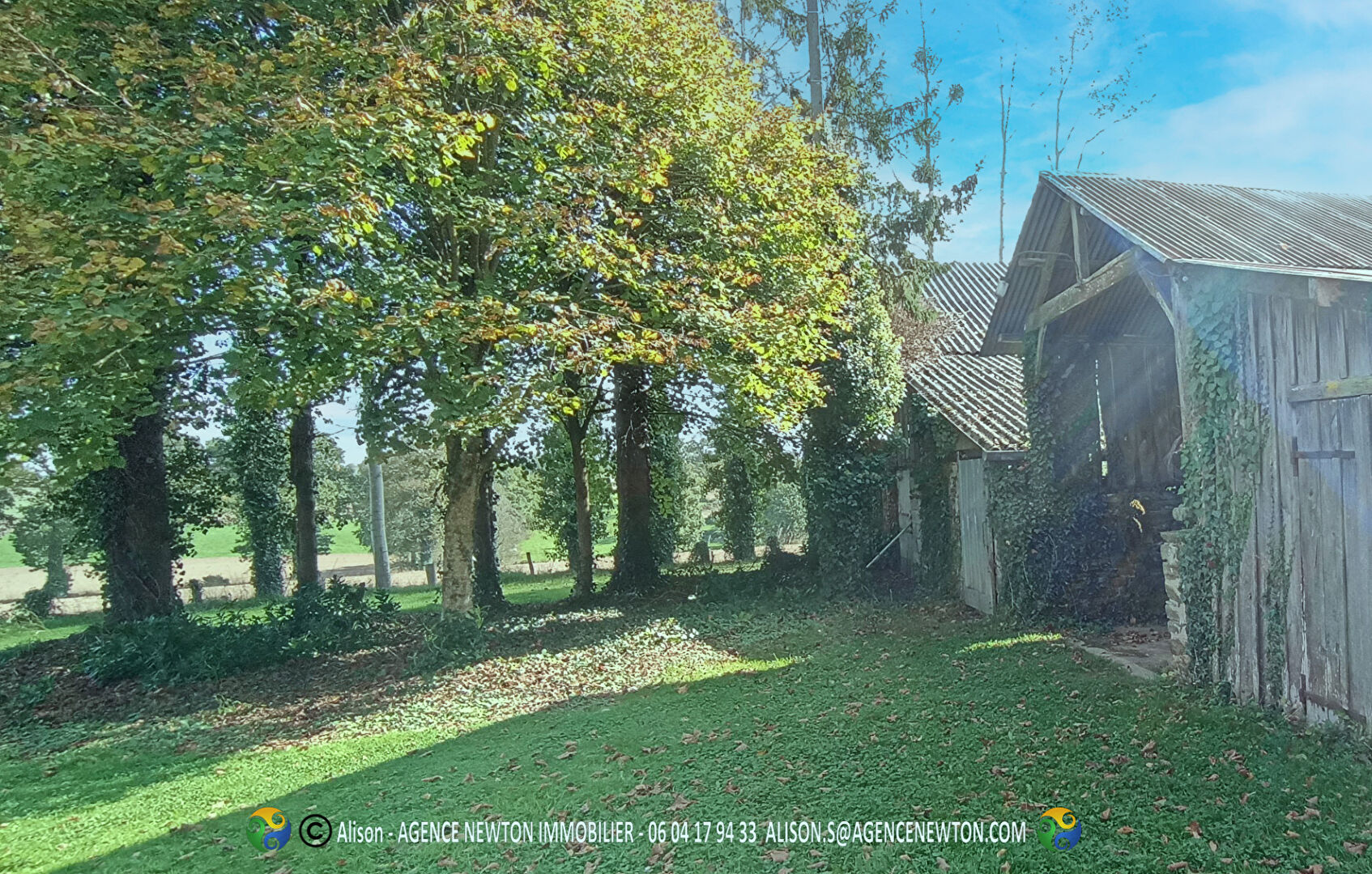 Property in Ille-et-Vilaine, Brittany featuring a spacious garden with trees and a rustic exterior.