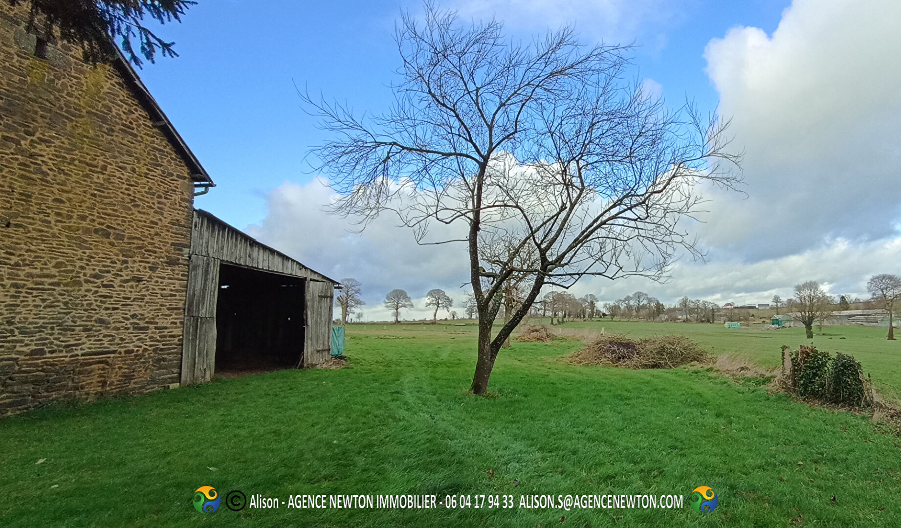 Property in Ille-et-Vilaine, Brittany, featuring a stone exterior, spacious garden, and surrounding countryside views.