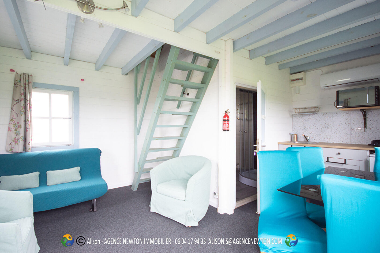 Bright interior of a property in Ille-et-Vilaine, Brittany, featuring a staircase, two bedrooms, and modern furnishings.