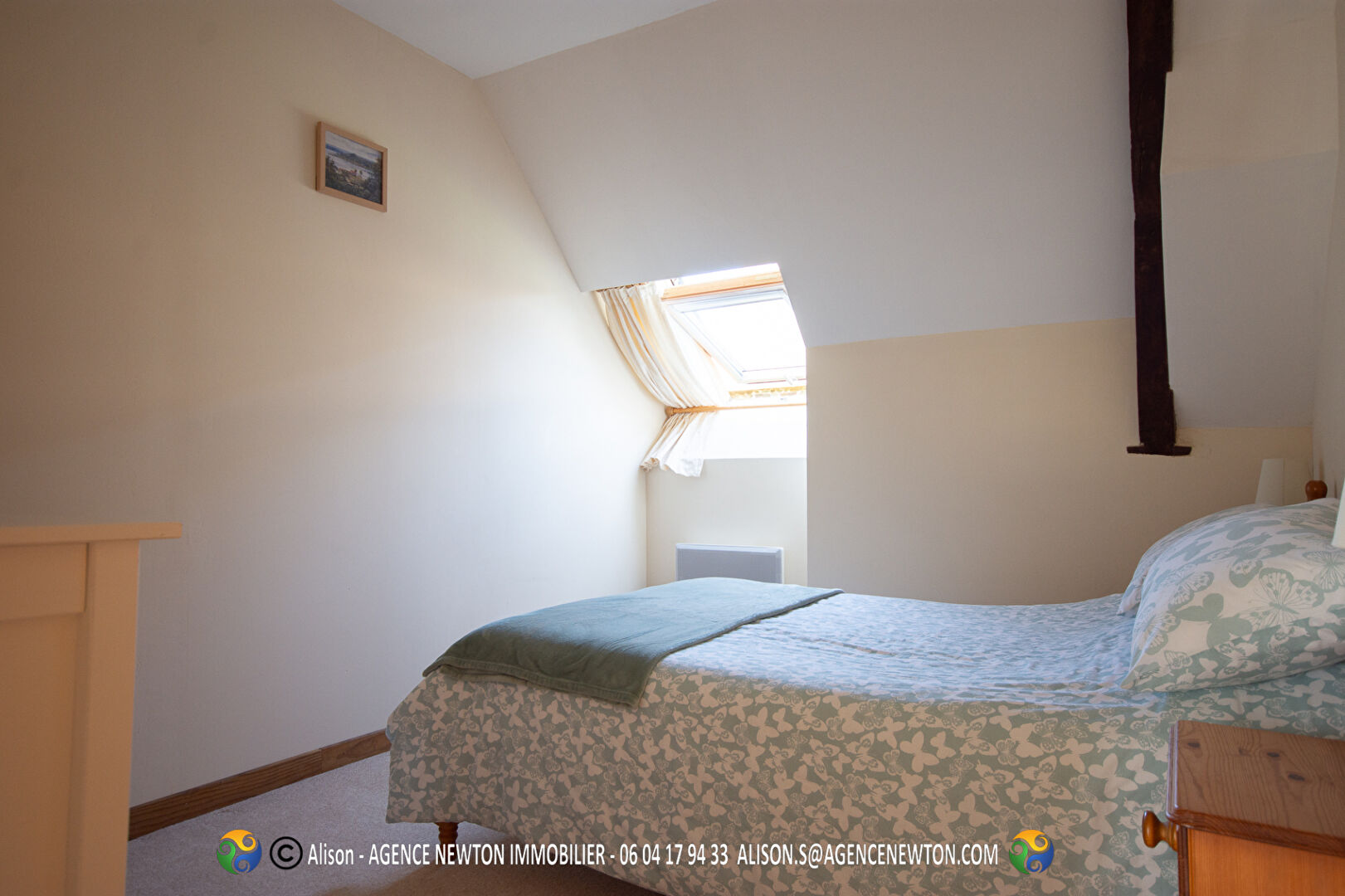Five-bedroom property in Mayenne, Pays-de-la-Loire, featuring a well-lit, cosy bedroom with sloped ceiling.