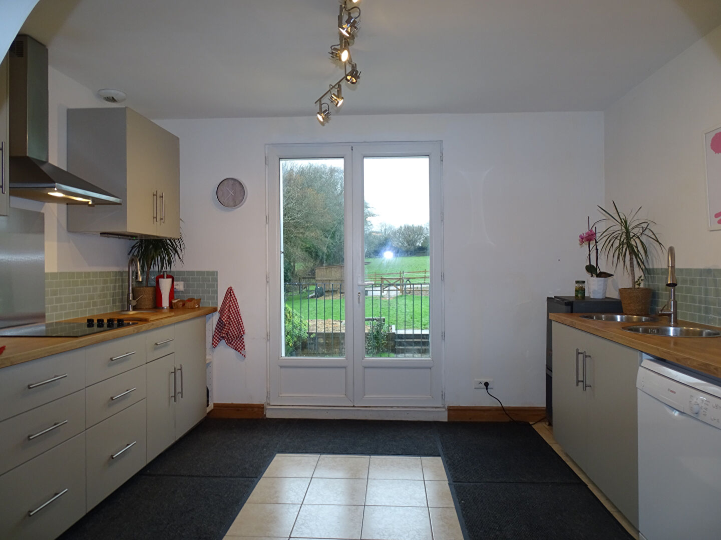 Modern kitchen with garden views in a property located in Morbihan, Brittany. Four bedrooms available.