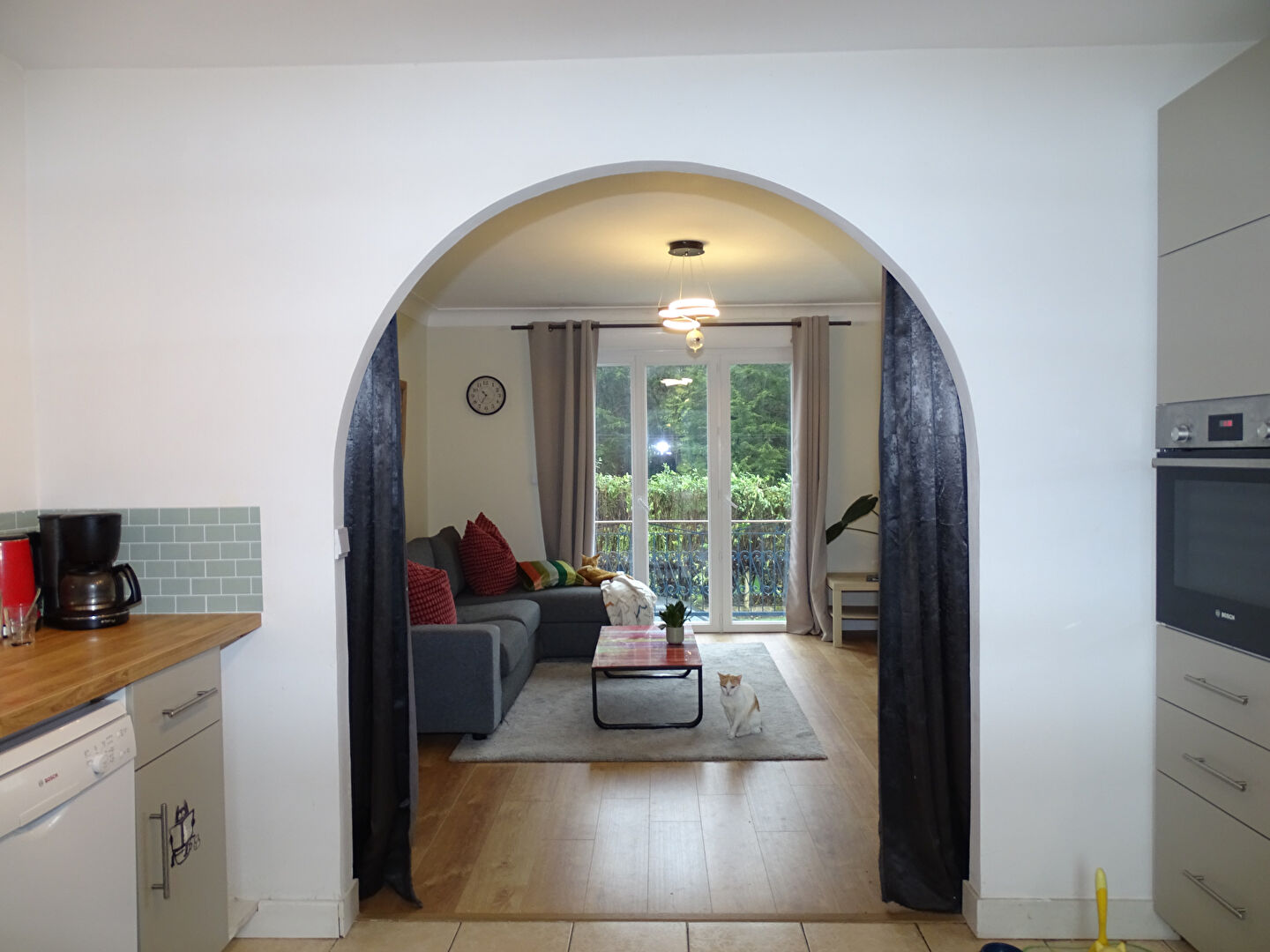 Spacious property in Morbihan, Brittany, featuring an archway leading to a comfortable living area with garden views.