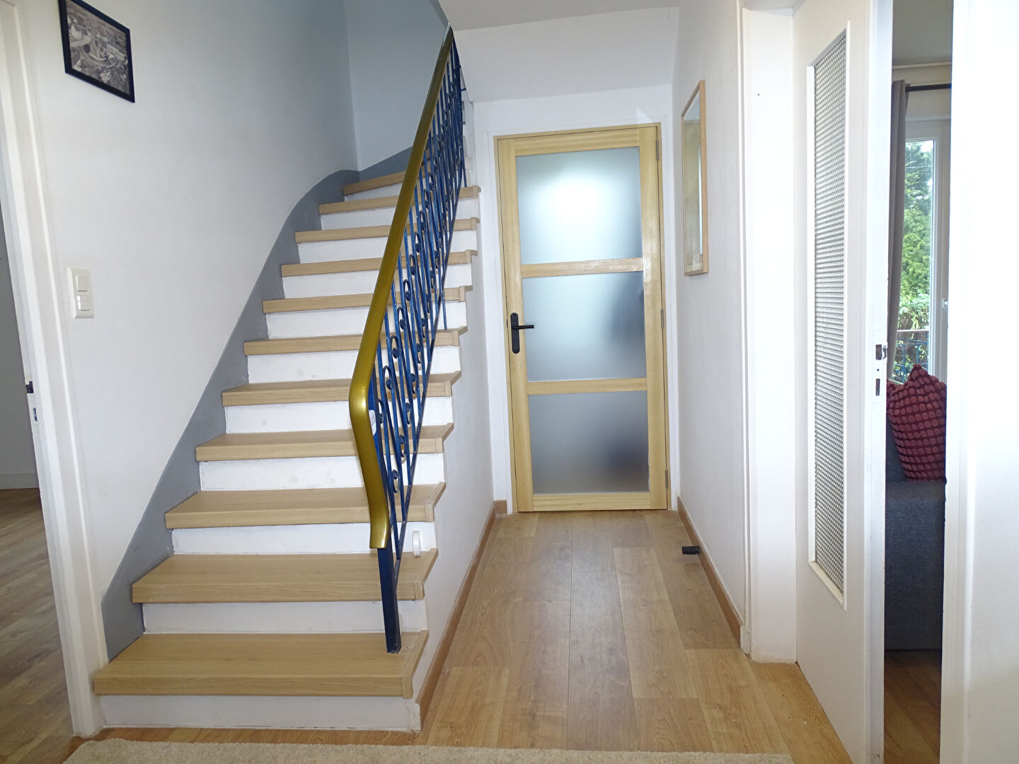 Interior of a property in Morbihan, Brittany, featuring a staircase and entrance door.