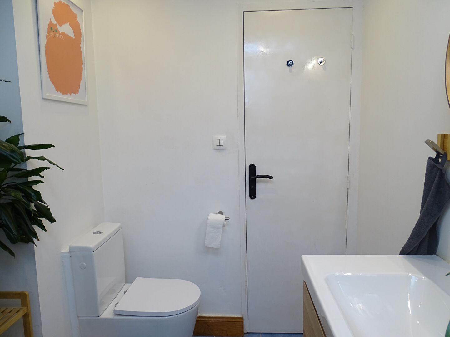 Modern bathroom featuring a toilet and sink in Morbihan, Brittany, with contemporary decor and minimalistic design.