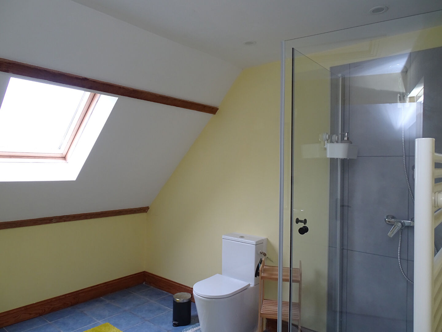 Modern property bathroom featuring a shower, skylight, and wooden accents in Morbihan, Brittany, postcode 56630.