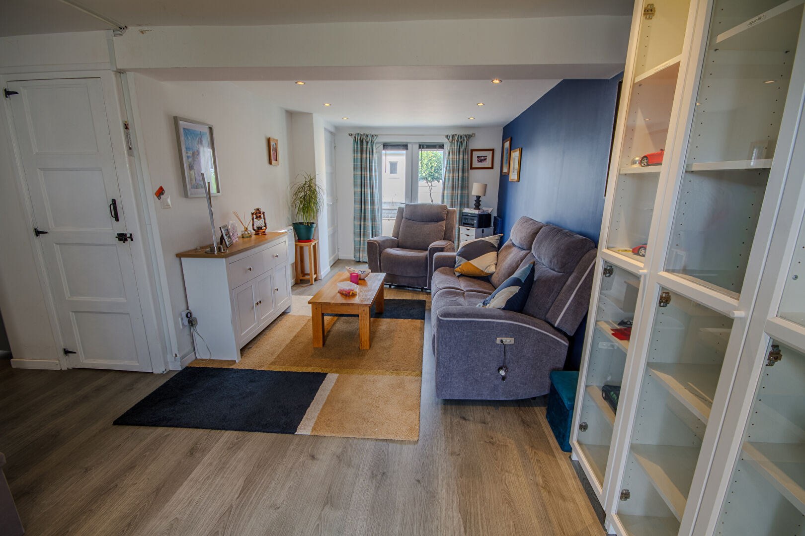 Modern property in Manche, Normandy, featuring a cosy living area with soft furnishings and natural light.