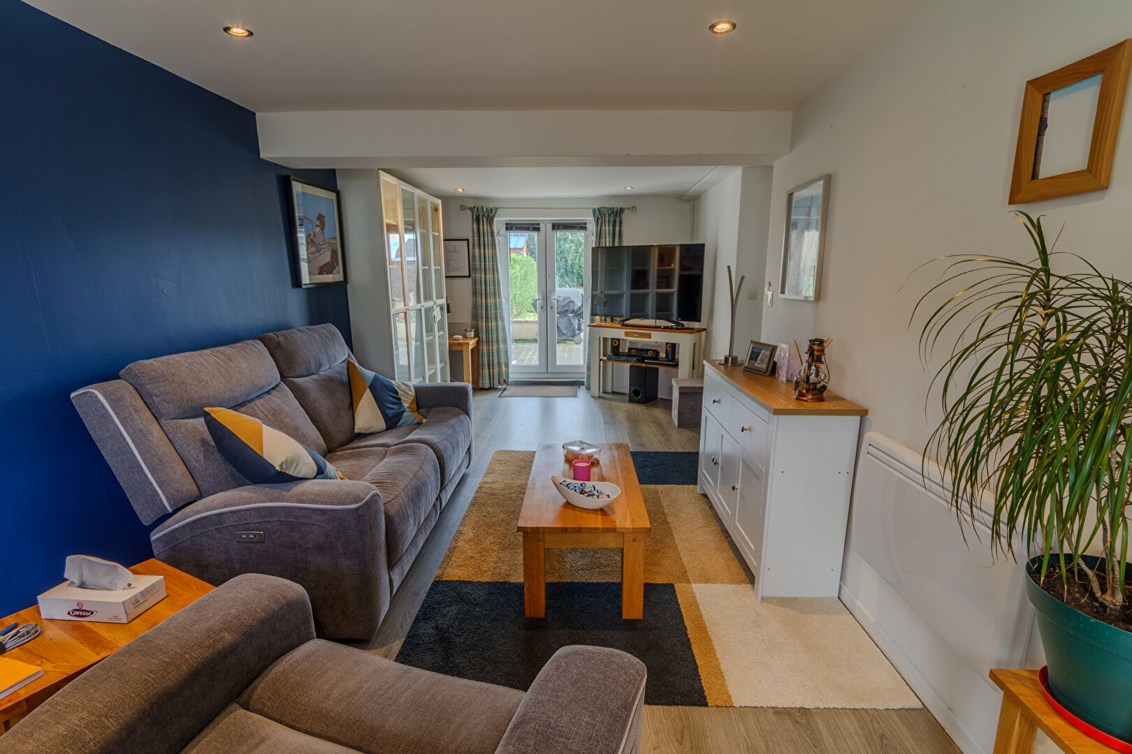Modern property in Manche, Normandy, featuring a comfortable lounge area with access to the garden.