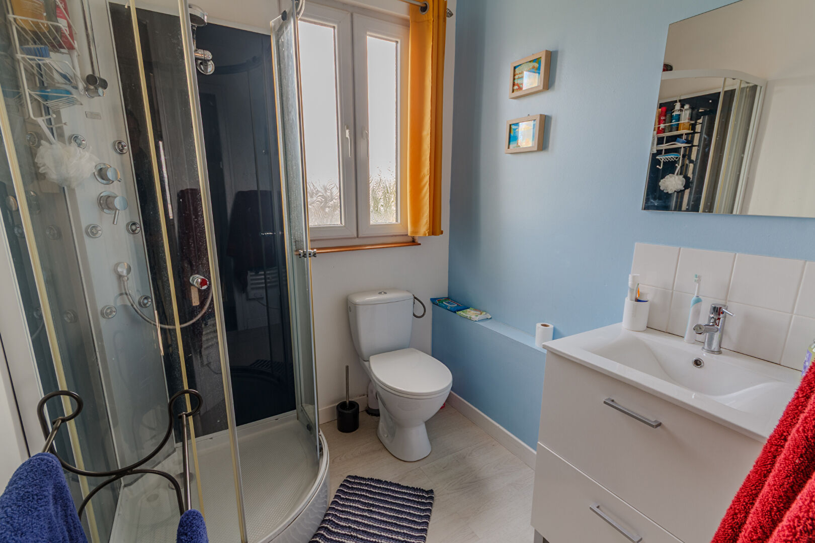 Modern bathroom featuring a shower, sink, and toilet in Manche, Normandy, 50150.