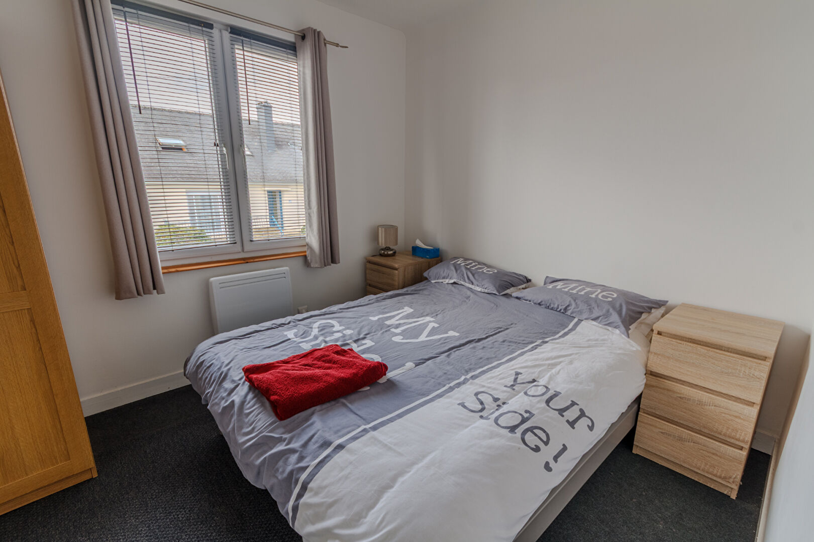 Spacious bedroom featuring a double bed and natural light, located in Manche, Normandy.