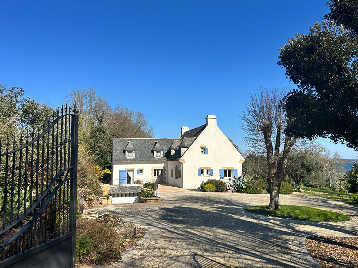 Spacious property in Finistère with a garden, palm trees, and views of the surrounding greenery.