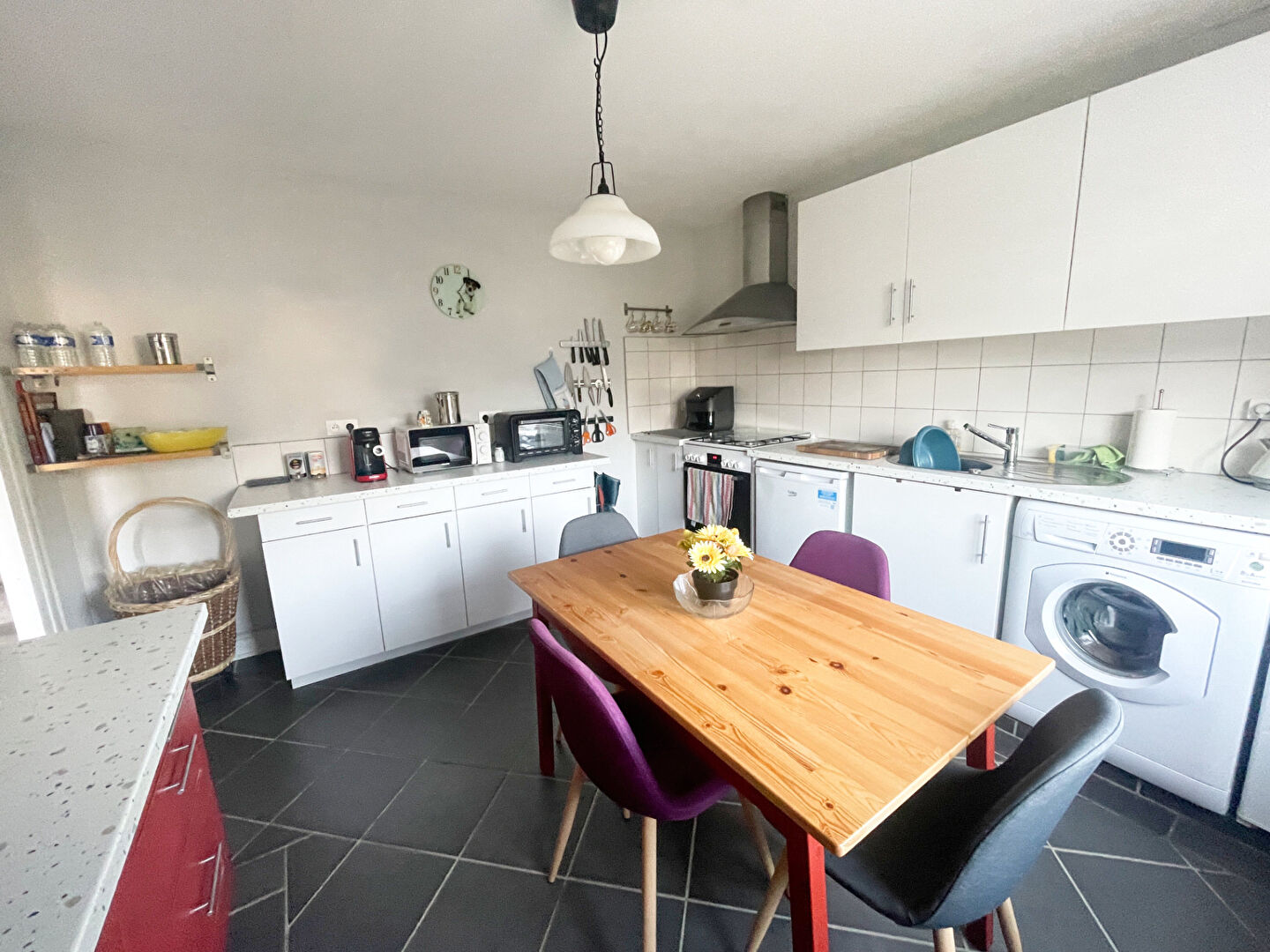 Modern kitchen in a property located in Finistère, Brittany, featuring a dining table and appliances.