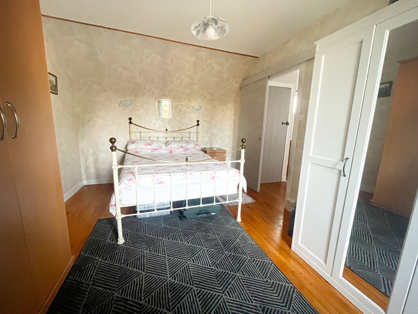Spacious property in Finistère, Brittany, featuring a bright bedroom with wooden flooring and natural light.